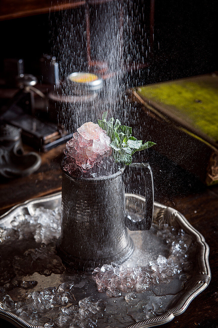 A cocktail in a pewter jug