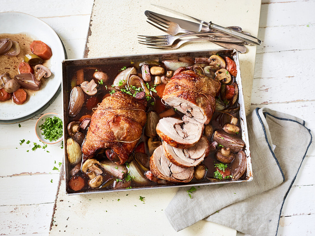 Marinated red wine turkey legs with mushrooms on a baking tray