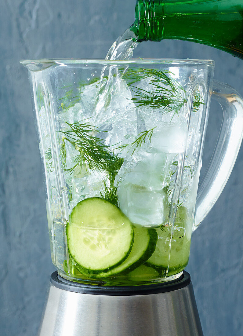 Ingredients for cucumber sangria with crushed ice in a blender