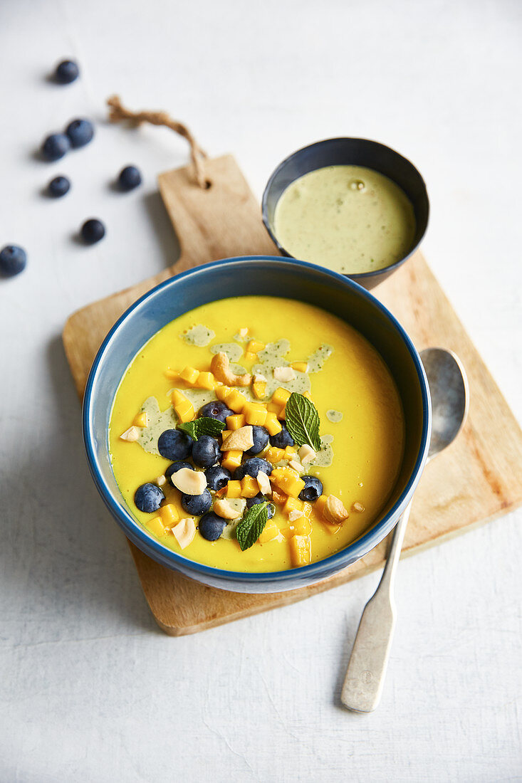 Golden mango milk with blueberries and turmeric