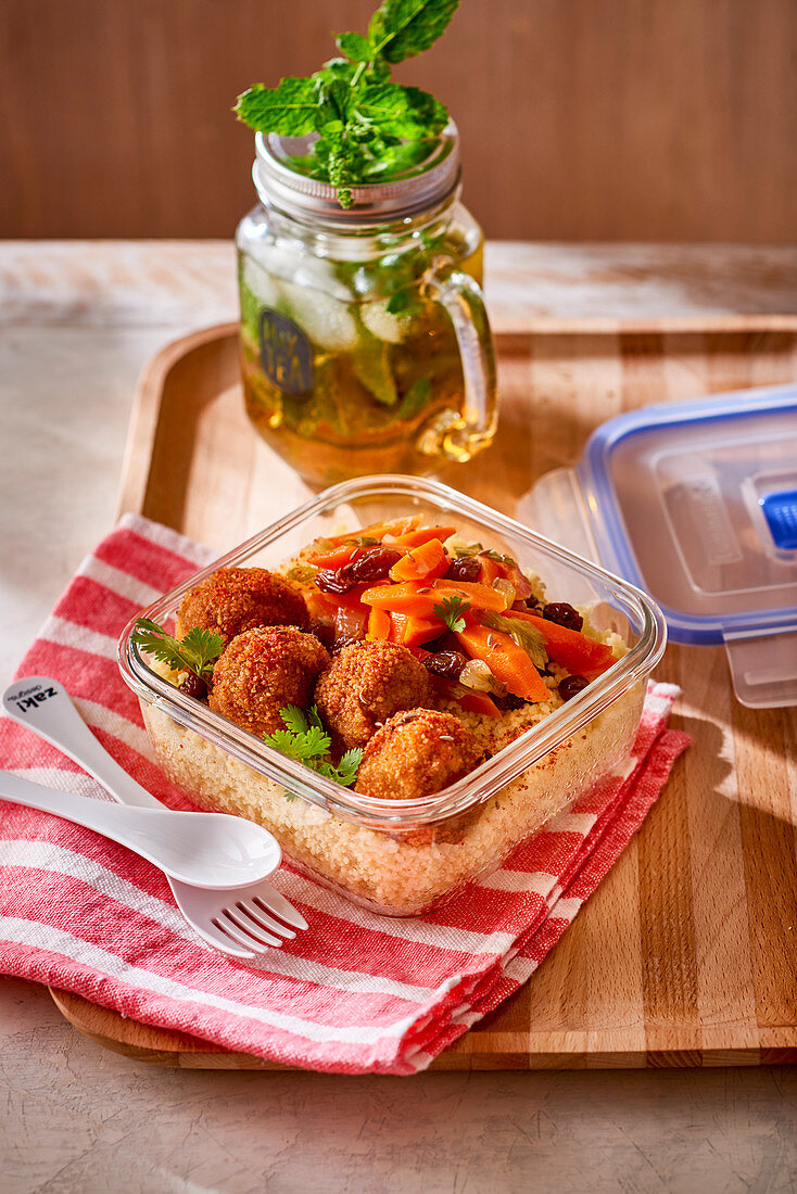 Lamb meatballs with vegetables on couscous in a tupperware box