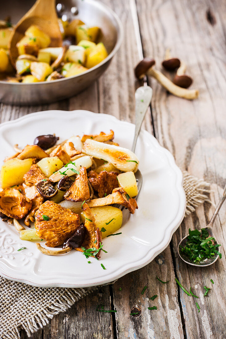 Fried potatoes with mushrooms and spring onions