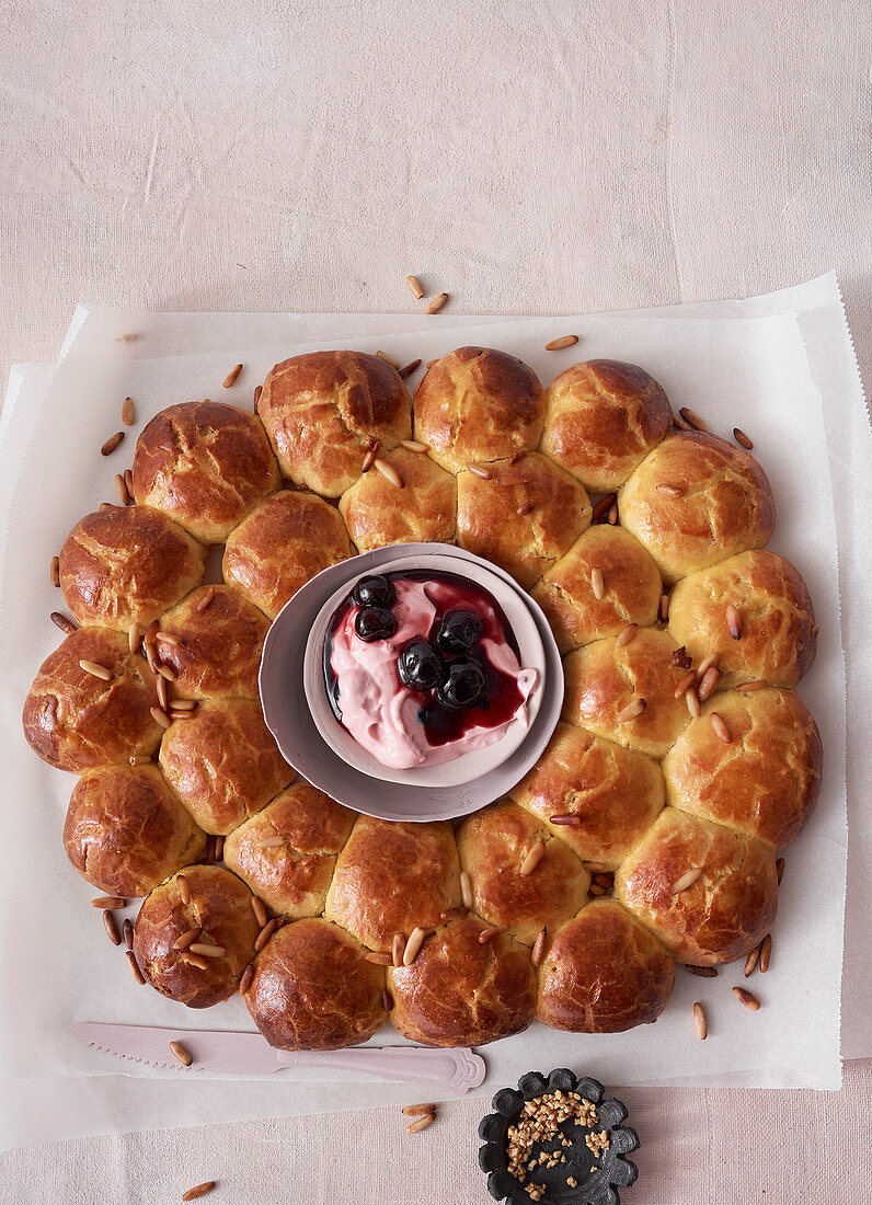 Orange and pine nut brioche wreath with amarena quark