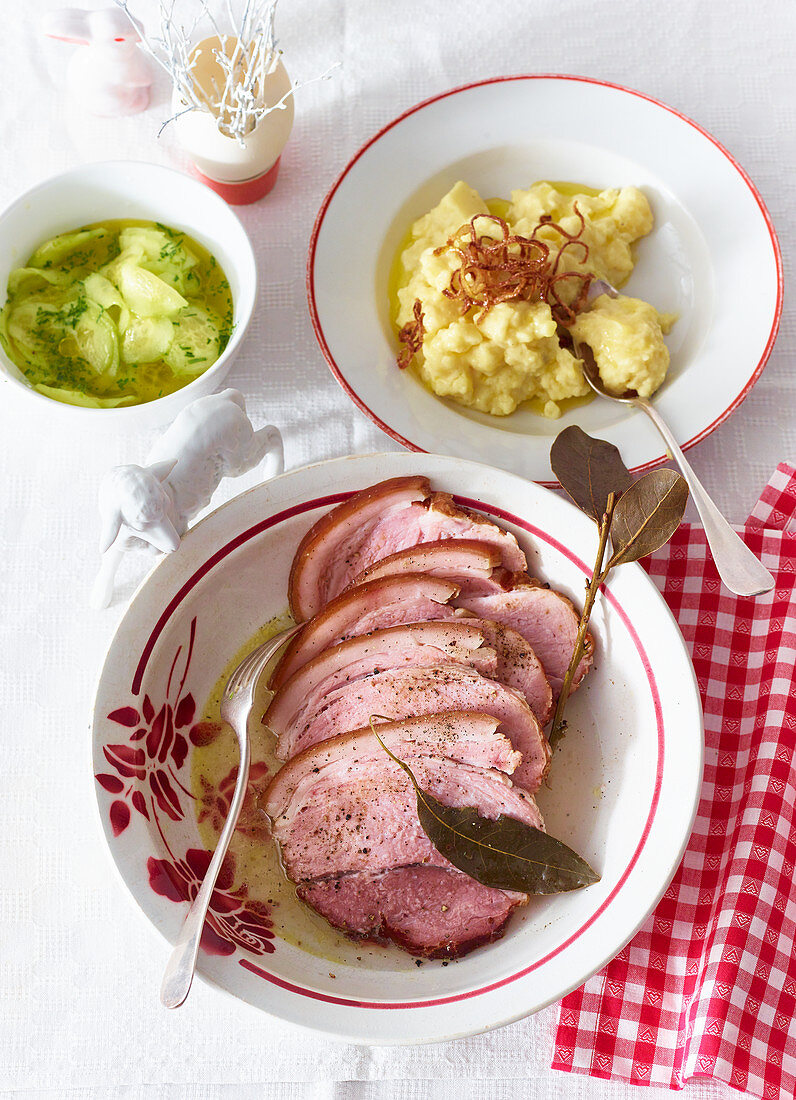 Smoked pork with mashed potatoes and cucumber salad for Easter (Austria)