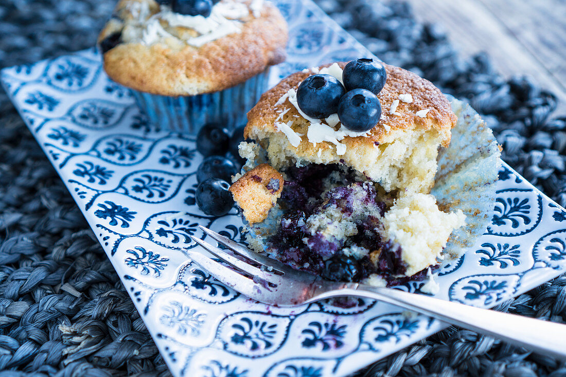 A blueberry muffin with a bite missing