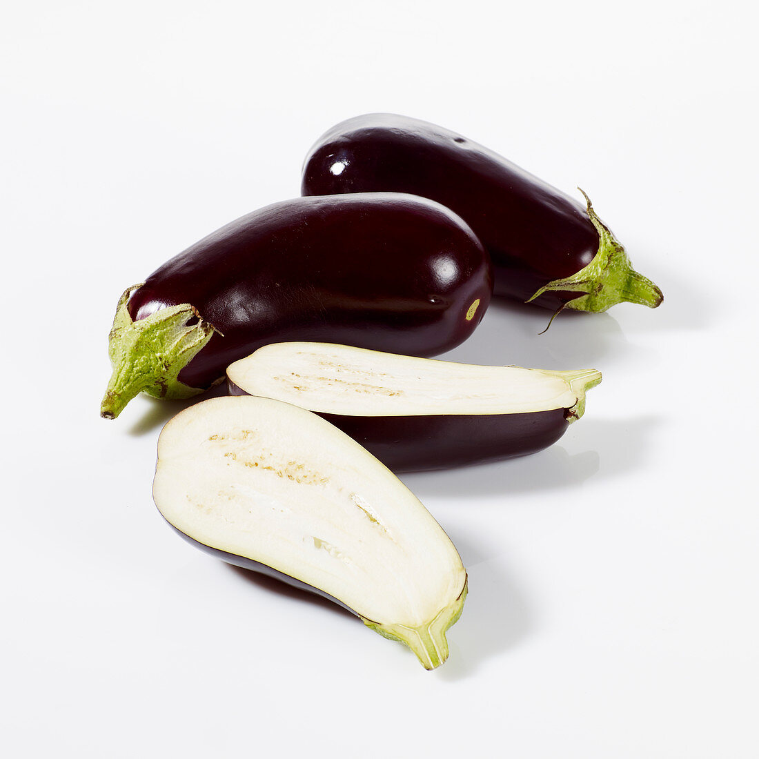 Aubergines, whole and halved