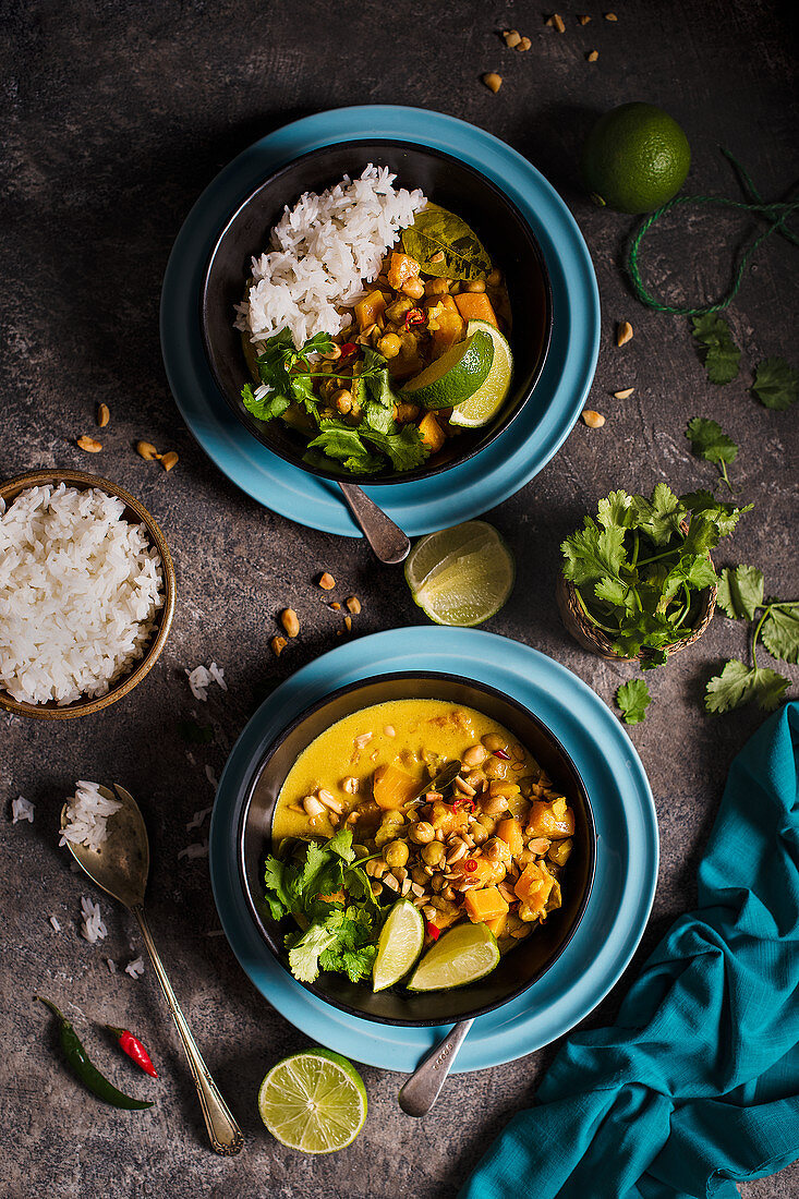 Vegeterian thai curry with squash and chickpeas, lime, coriander and toasted peanuts, view from above