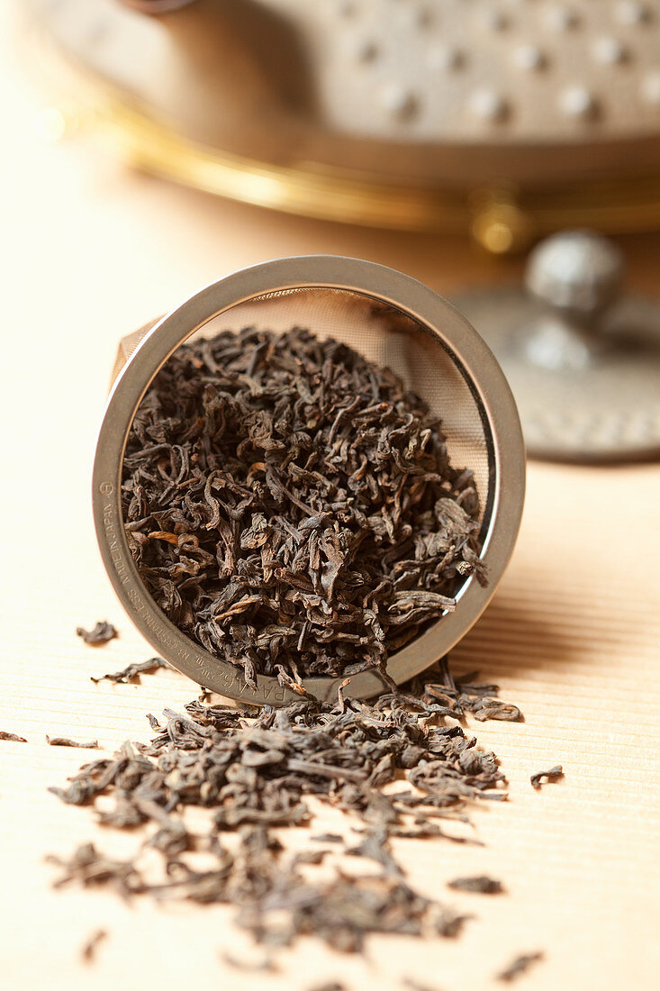 Pu Erh tea leaves in a tea strainer