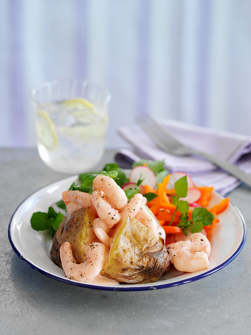 A baked potato with prawns