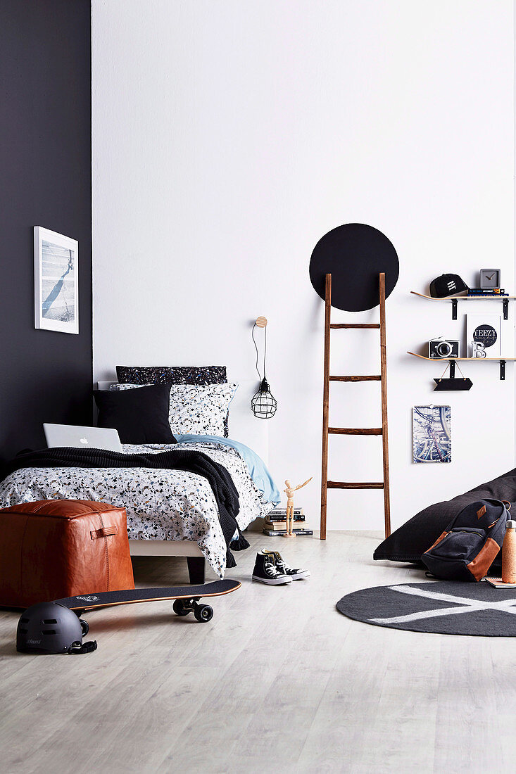 Black and white youth room with ladder and DIY shelf made of skateboards