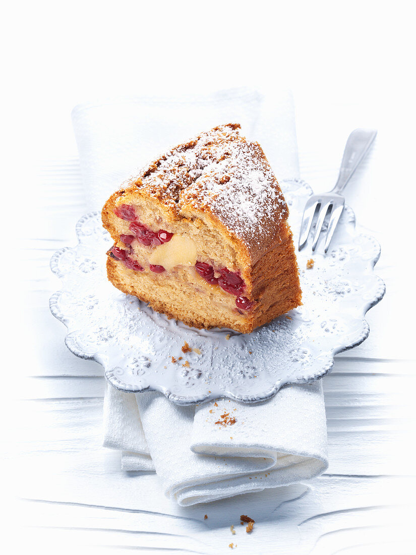 A slice of apple and cinnamon cake with cherries
