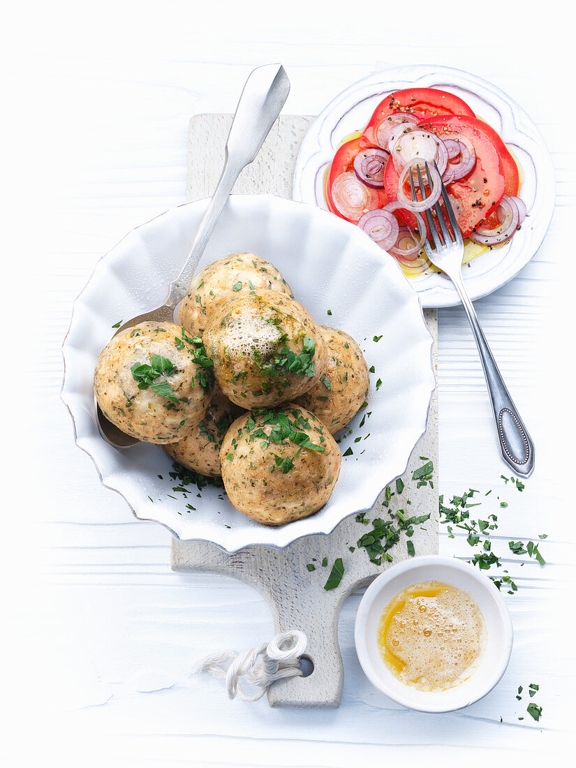 Cheese dumplings with parsley and a tomato salad