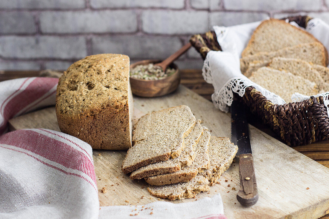Wholewheat bread on a chopping board and in a bread basket
