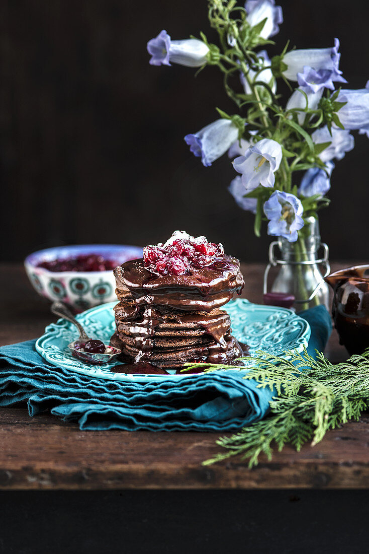 Chocolate pancakes with cranberry compote and chocolate sauce