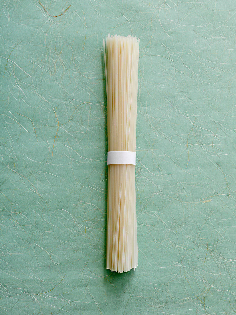 A bundle of rice noodles on a textured background