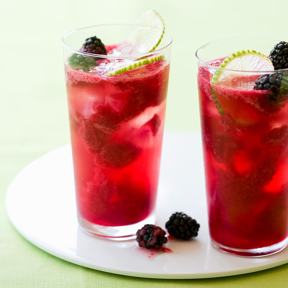 Two glasses of Blackberry Lime Rickey cocktails
