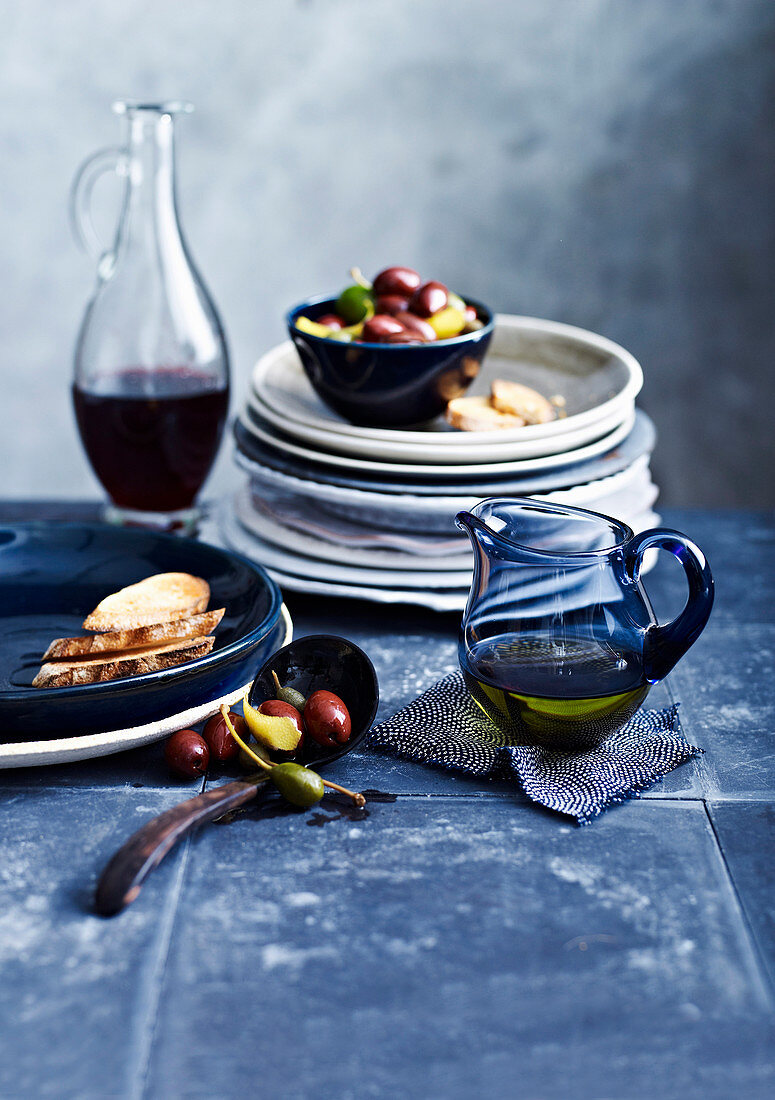 Mediterrane Tischszene mit Oliven und Kapernäpfeln