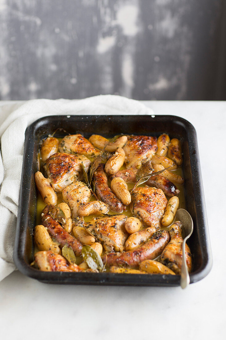 Chicken and sausage roasted in tray with white wine and bay