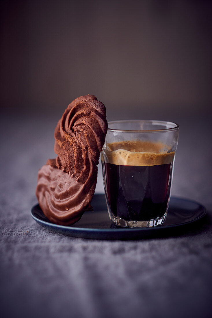 Chocolate piped biscuits with a glass of coffee