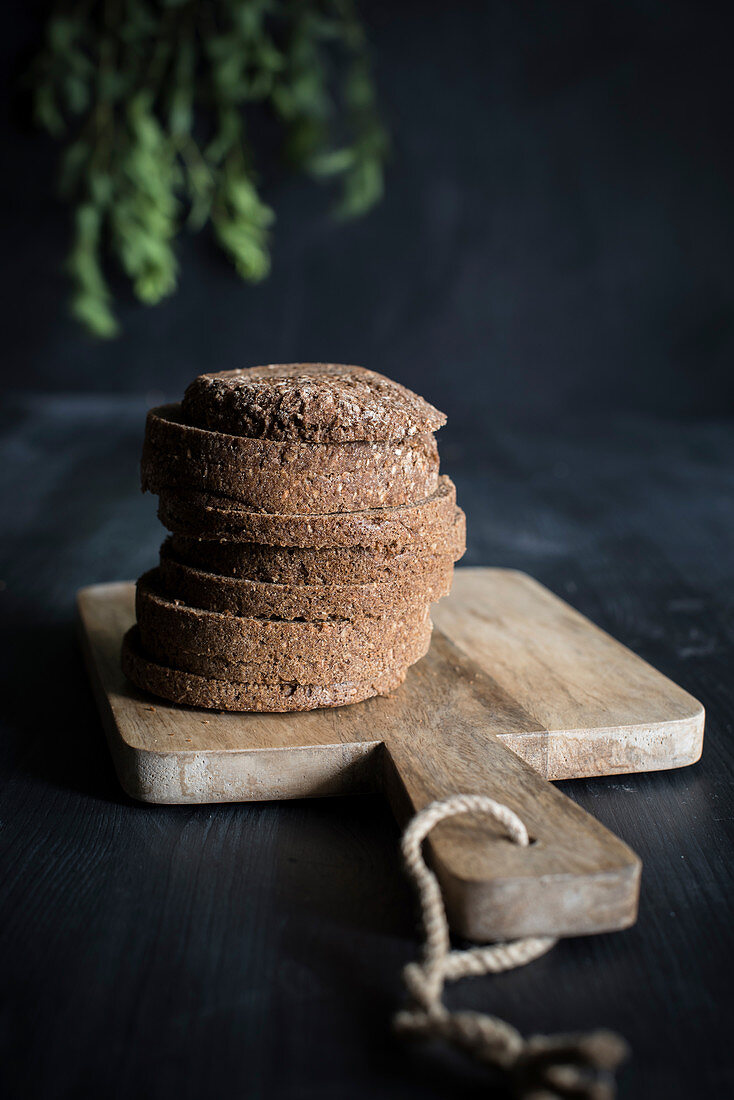 Sliced black bread on a wooden chopping board