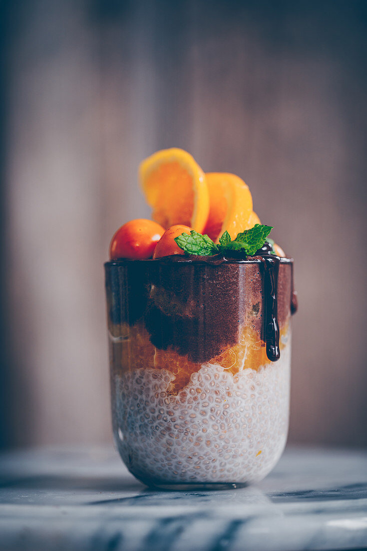 Chia pudding with fresh oranges, chocolate cream, mint and physalis