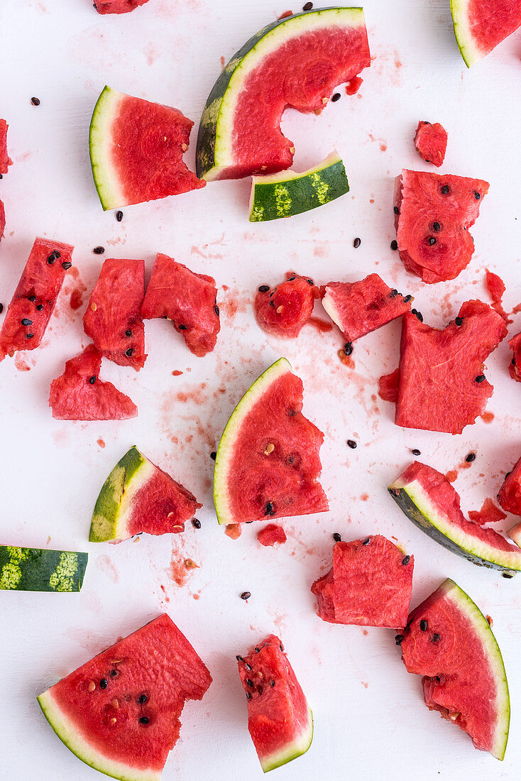 Watermelon pieces, some with bites taken out (seen from above)