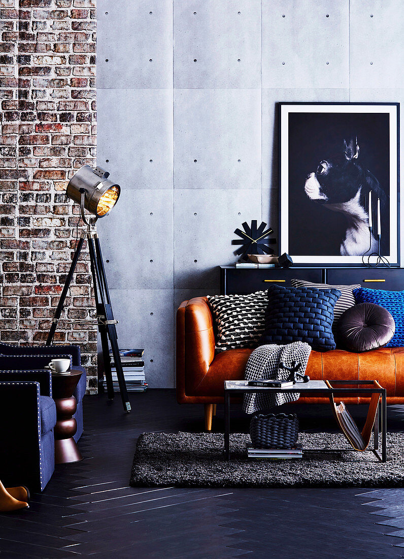 Masculine living room in a blue industrial style with leather sofa