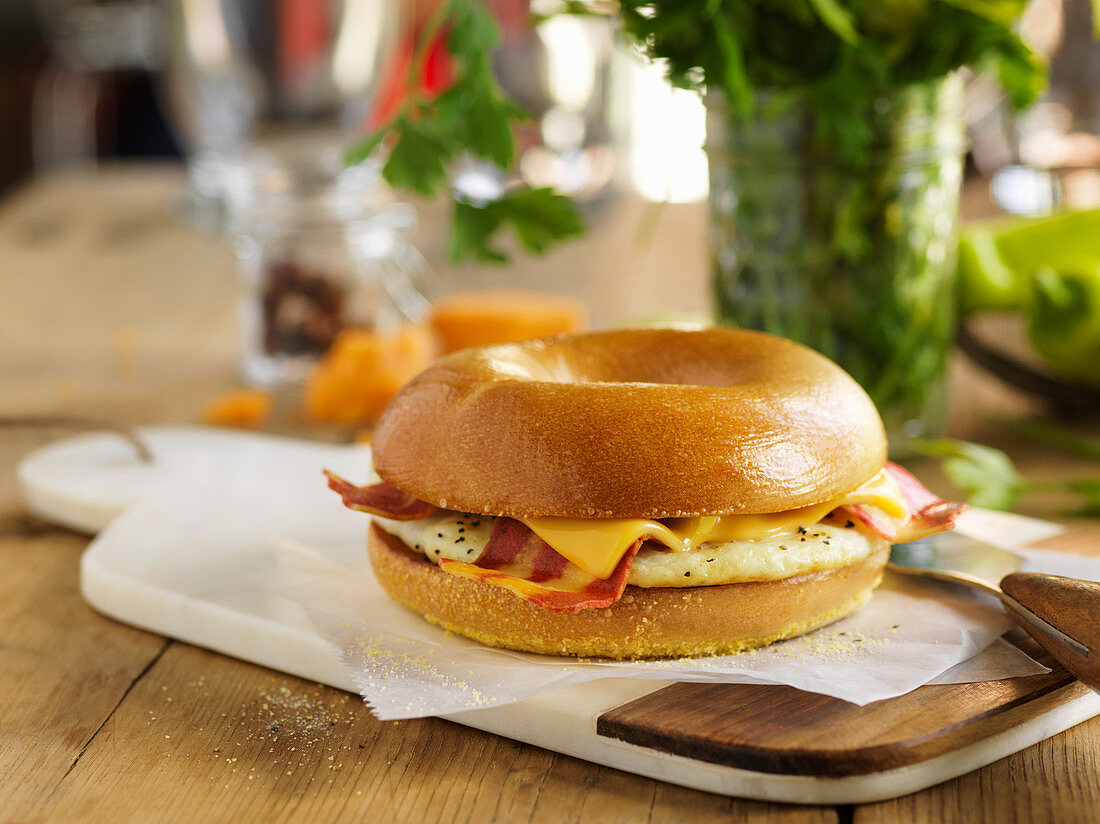 A bagel filled with egg, cheese and bacon