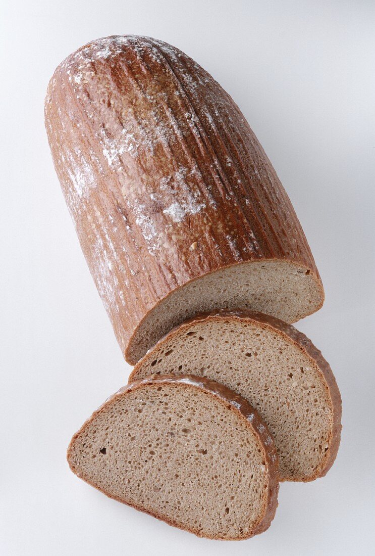 A Loaf of Wheat Bread with Two Slices