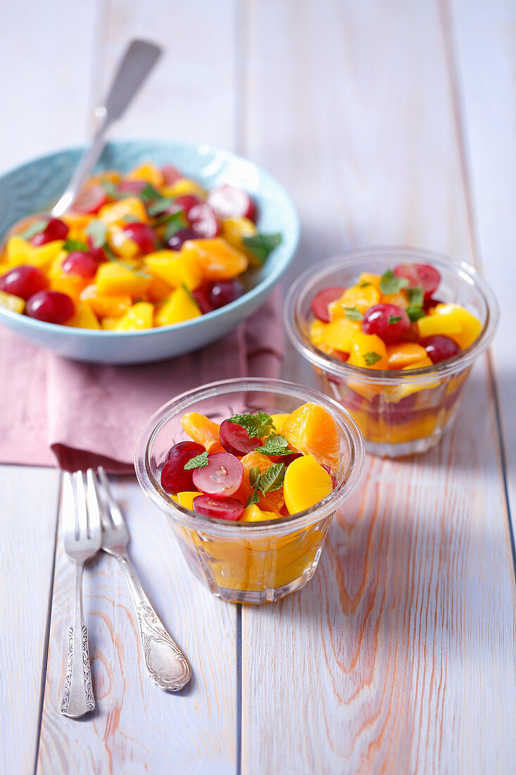Fruit salad with peach, grapes, tangerines and mint