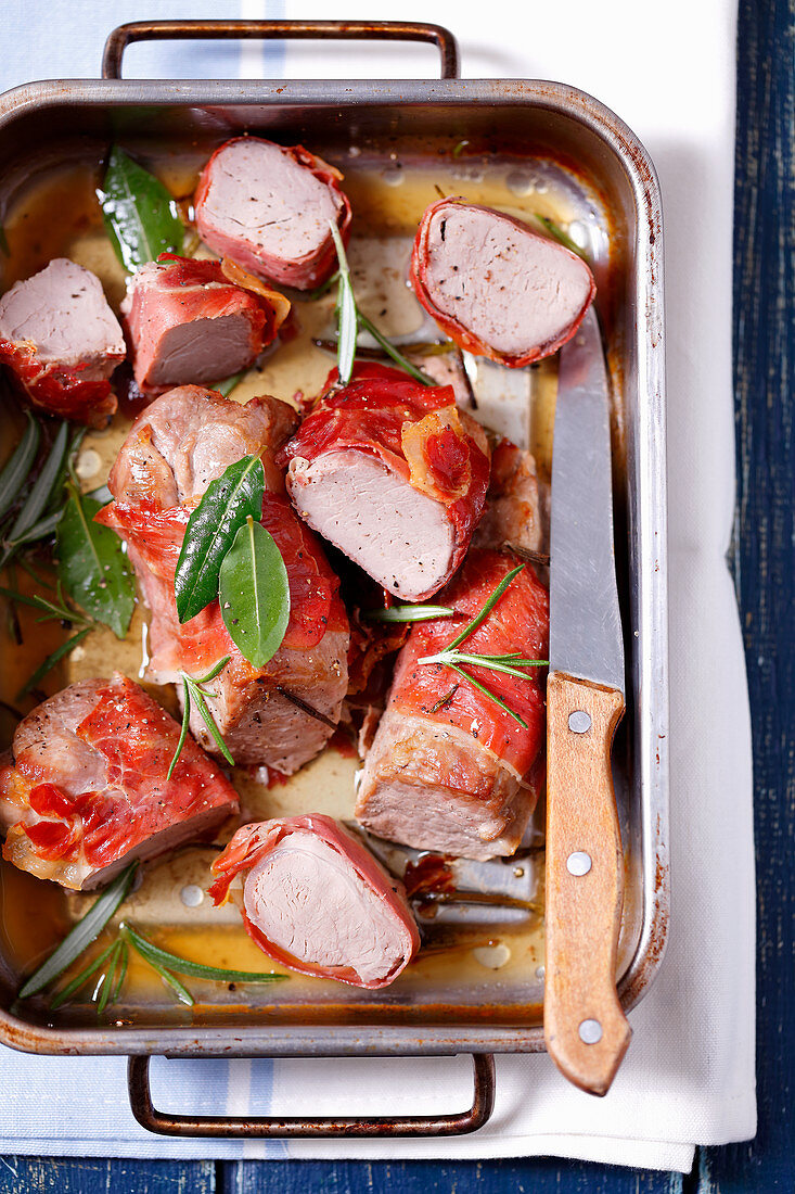 Baked pork loin wrapped with prosciutto