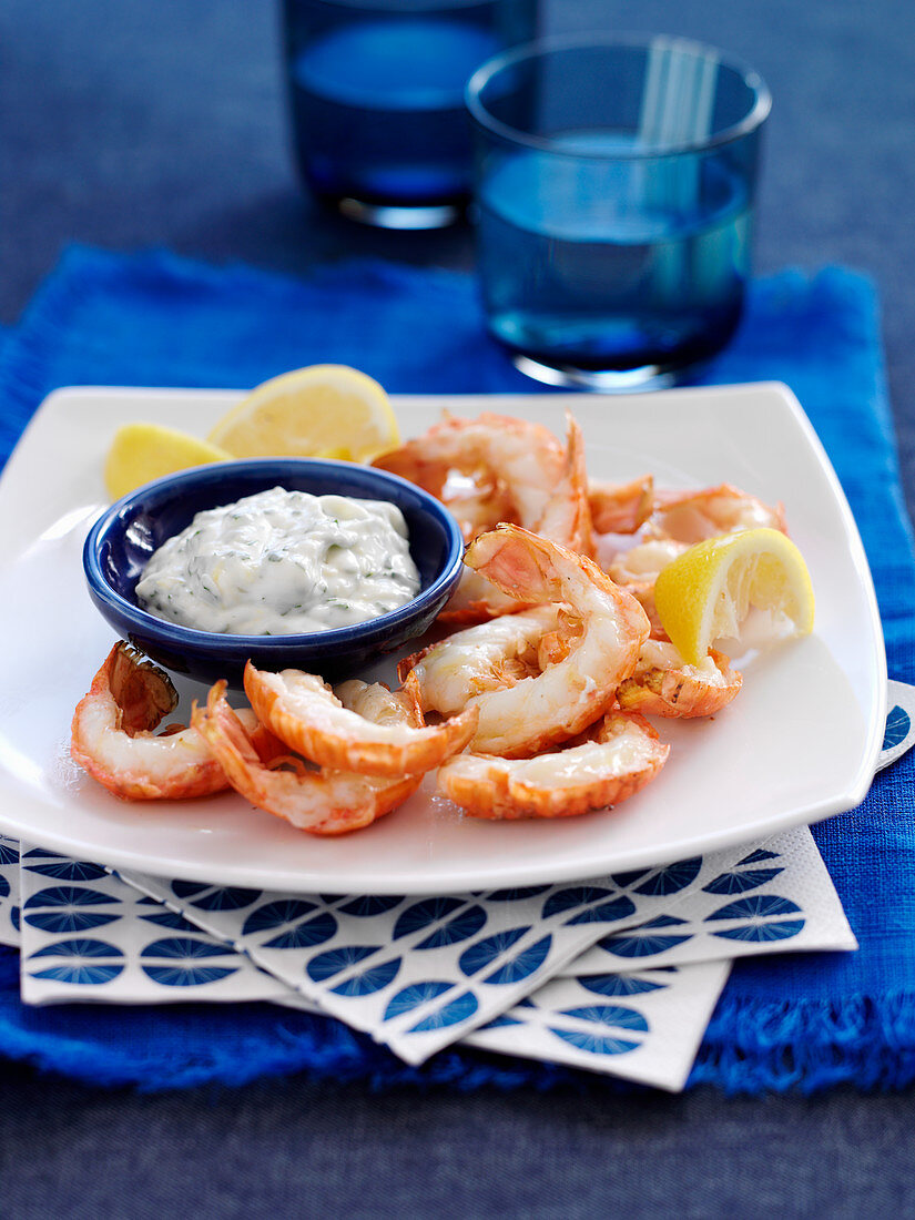 Langoustines with lemon wedges and a dip