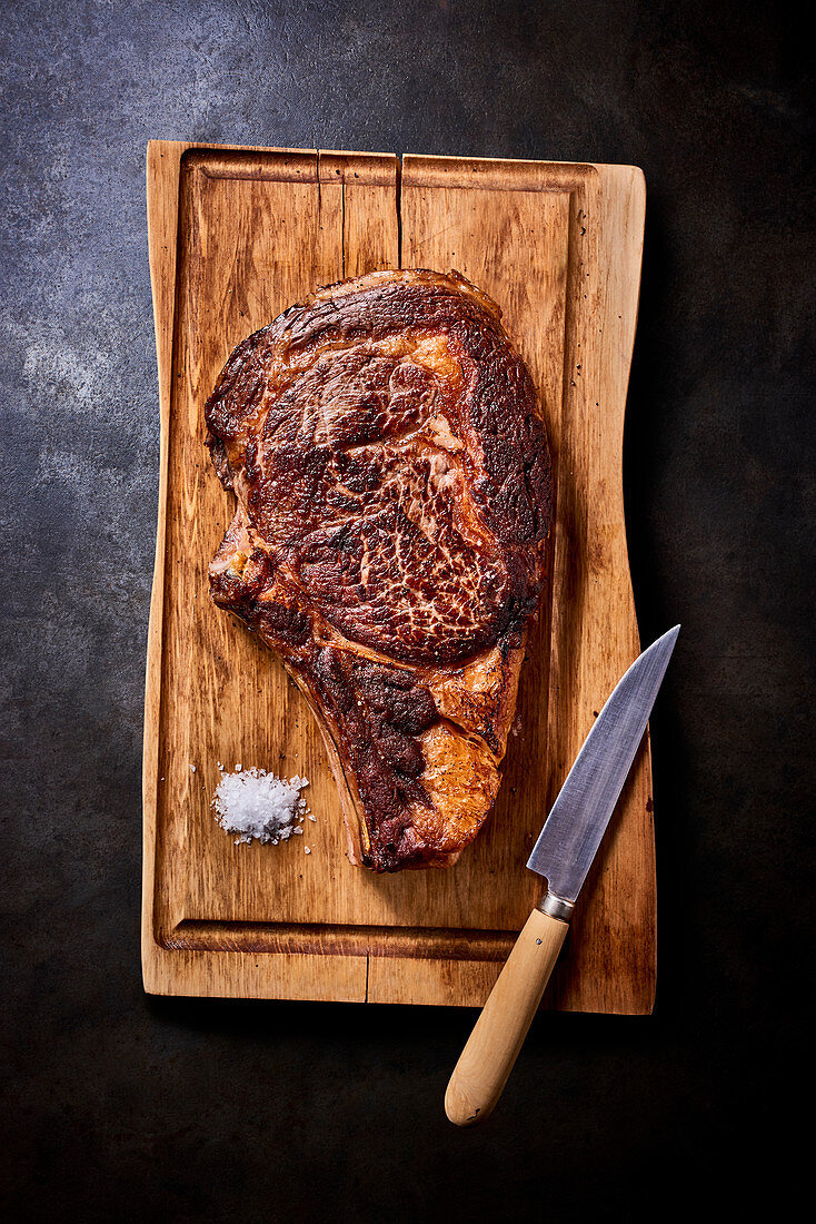 Seared beef steak on a wooden chopping board