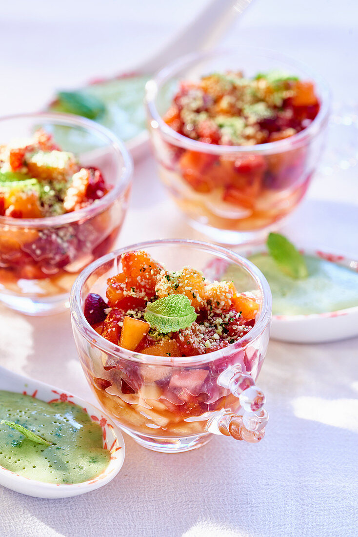Fruit salad with pistachio nuts and basil sauce