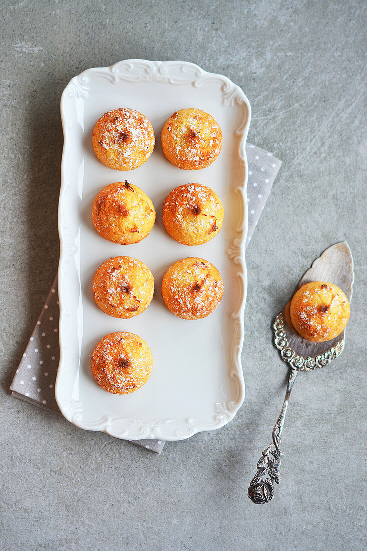 Almond cakes on a porcelain tray and an old cake slice