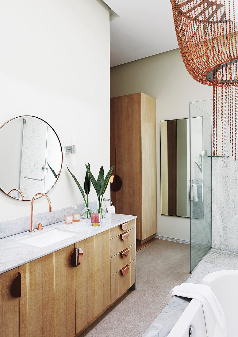 Long wooden washstand in modern bathroom