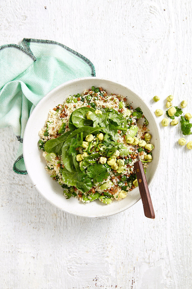 Couscous salad with onions, spinach, coriander greens, lentils, garlic and green chilli