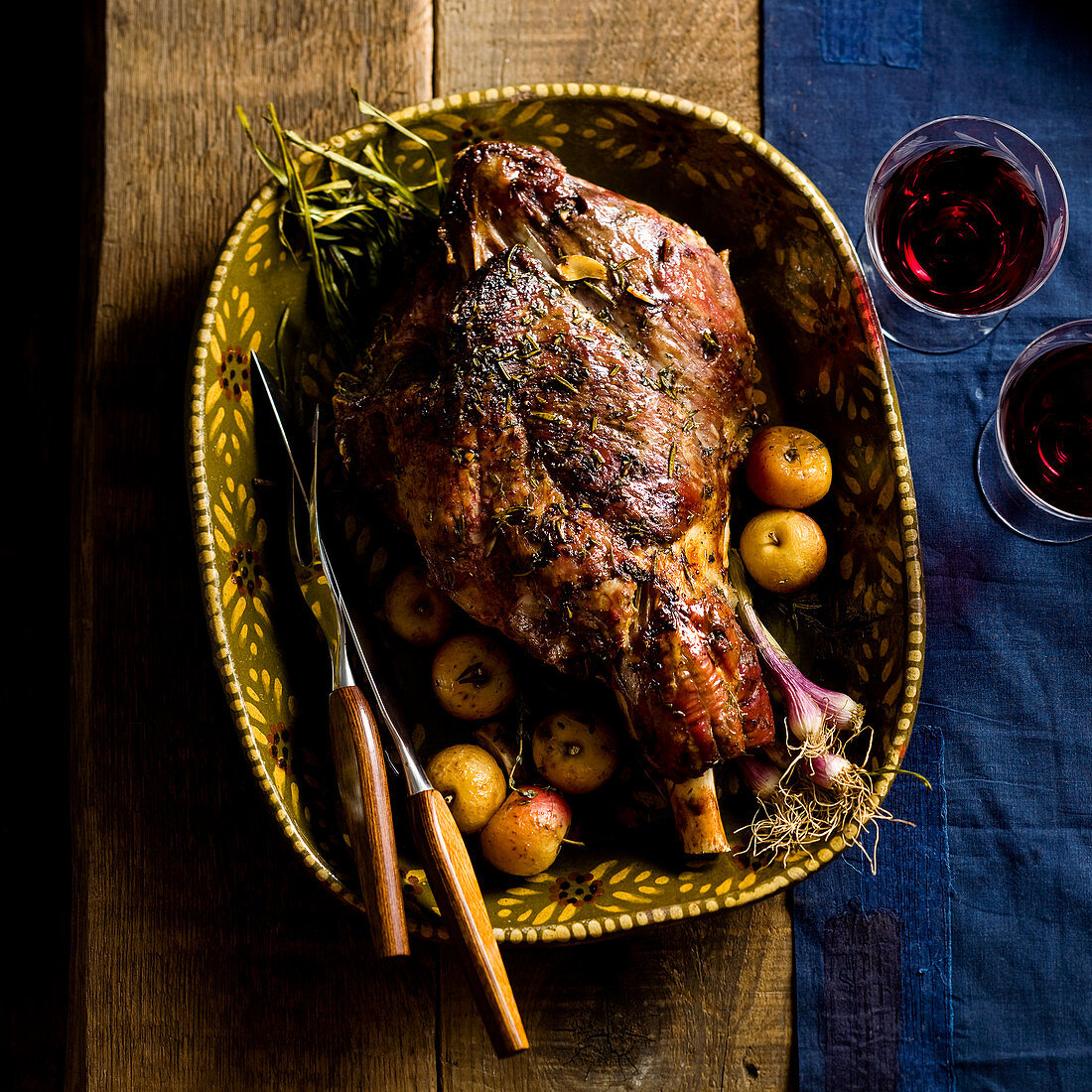 A roasted leg of lamb with herbs and apples