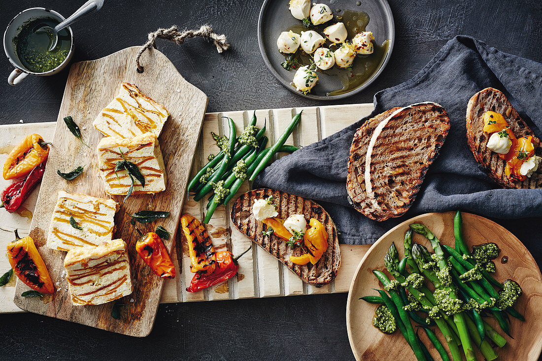 An antipasti plater with pumpkin and ricotta frittata, green beans, asparagus, basil pesto, grilled bread, mini peppers and marinated bocconcini