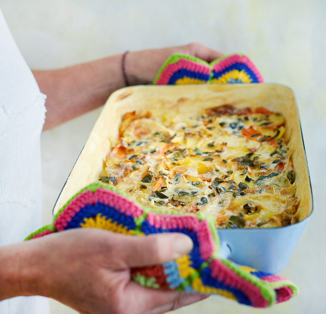 Carrot and potato gratin with pumpkin seeds