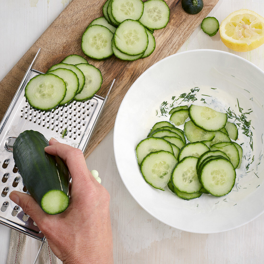 Cucumbers being sliced for a salad