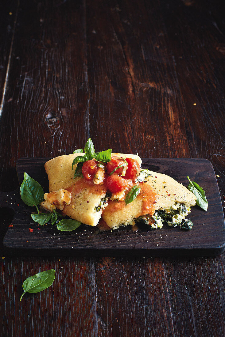 Spinach and ricotta calzone with caprese sauce