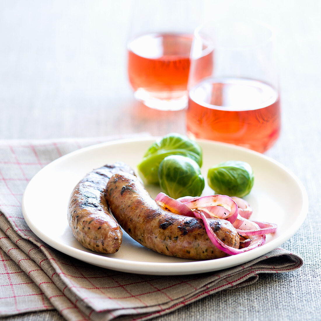 Sausages with red onions and Brussels sprouts