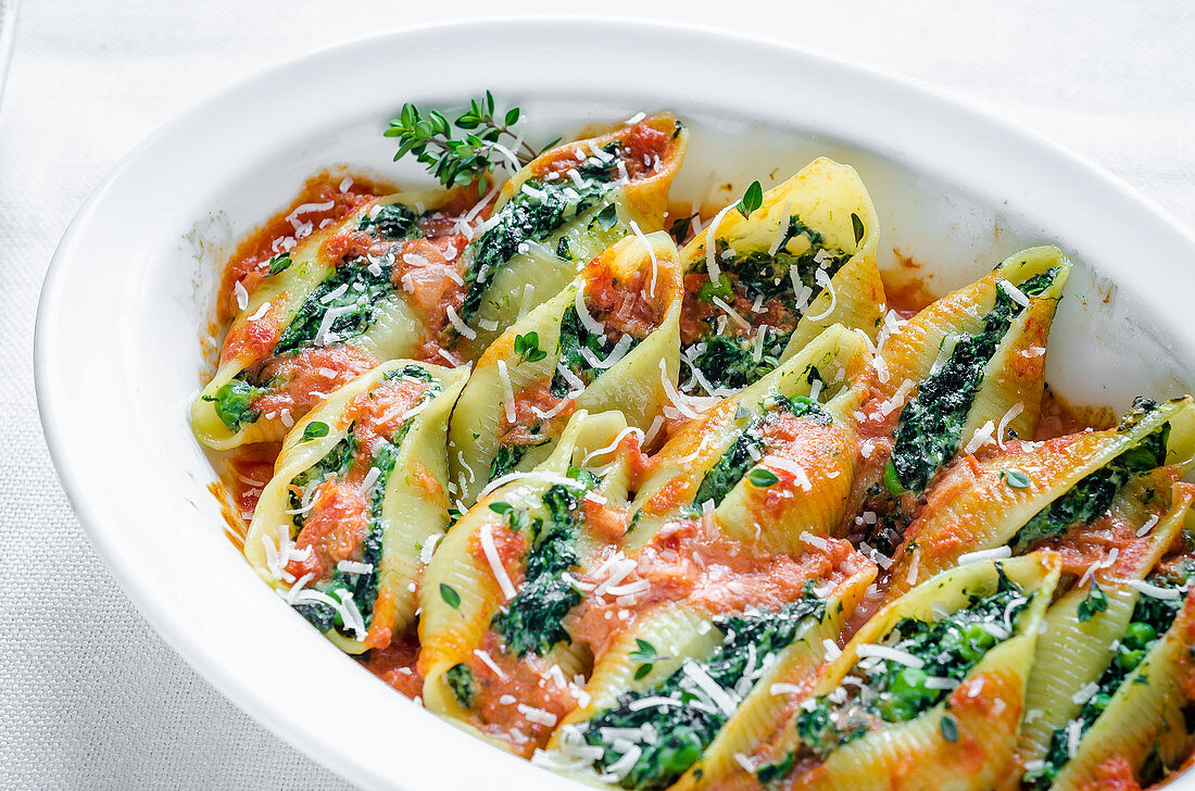 Shell pasta with a spinach-ricotta filling in tomato sauce with Parmesan