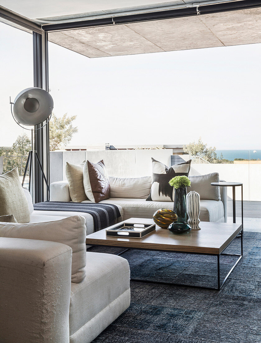 Luxurious living room with glass walls and sea view