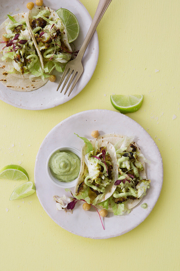 Fish tacos with iceberg lettuce, an avocado dip, and micro herbs