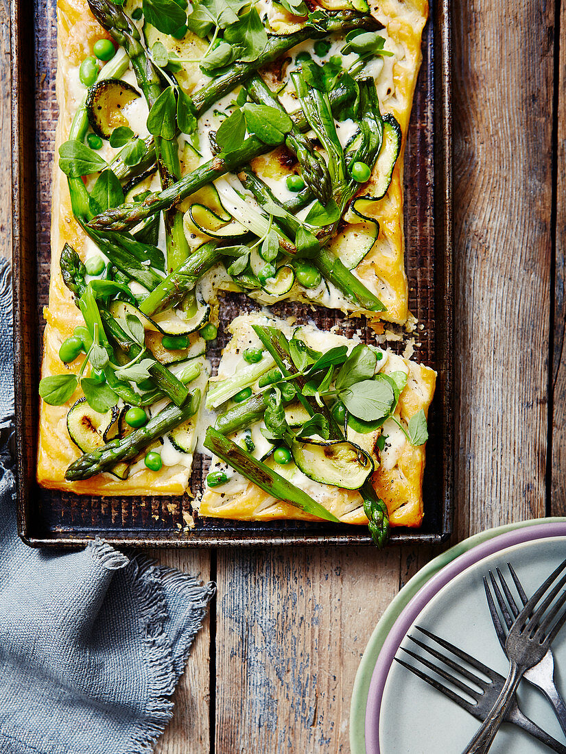 A Spring Pea Asperagus and Corgette Tart with a cut slice