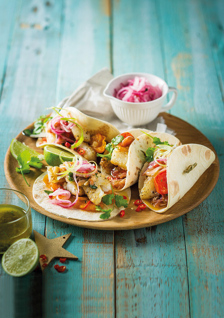 Spicy fish tacos with red onions