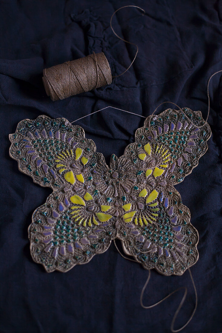 Clay butterfly embossed with lace pattern and painted