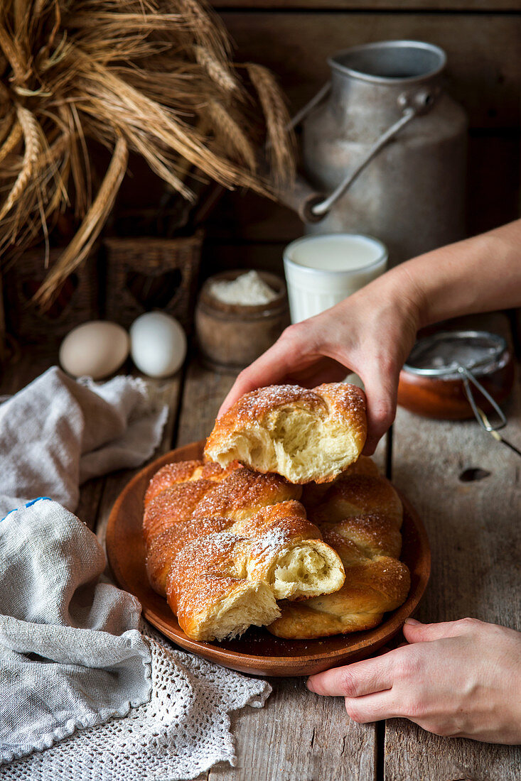 Sweet homemade bread with female hands